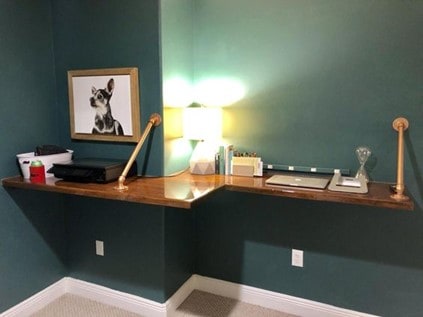 polished wood floating desk in a small home office
