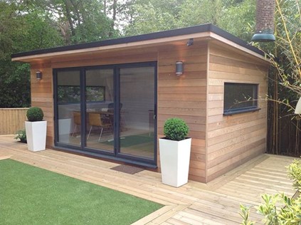 furnished wooden slate garden office with glass sliding doors