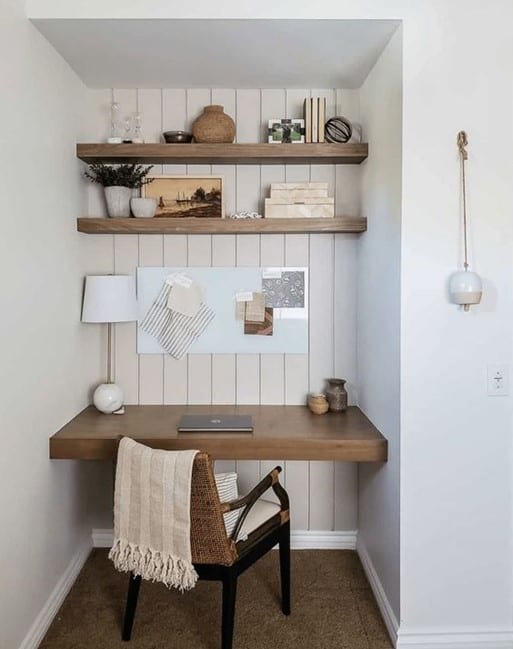 small home office nook with wooden desk, floating shelves and shiplap walling