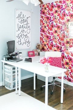 pink floral office with floral wall paper and white desk 