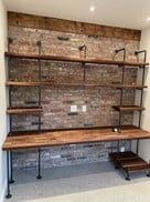 brick wall and butcher block office desk built-in