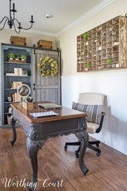 farm house rustic home office with vintage wooden desk and barn door closet